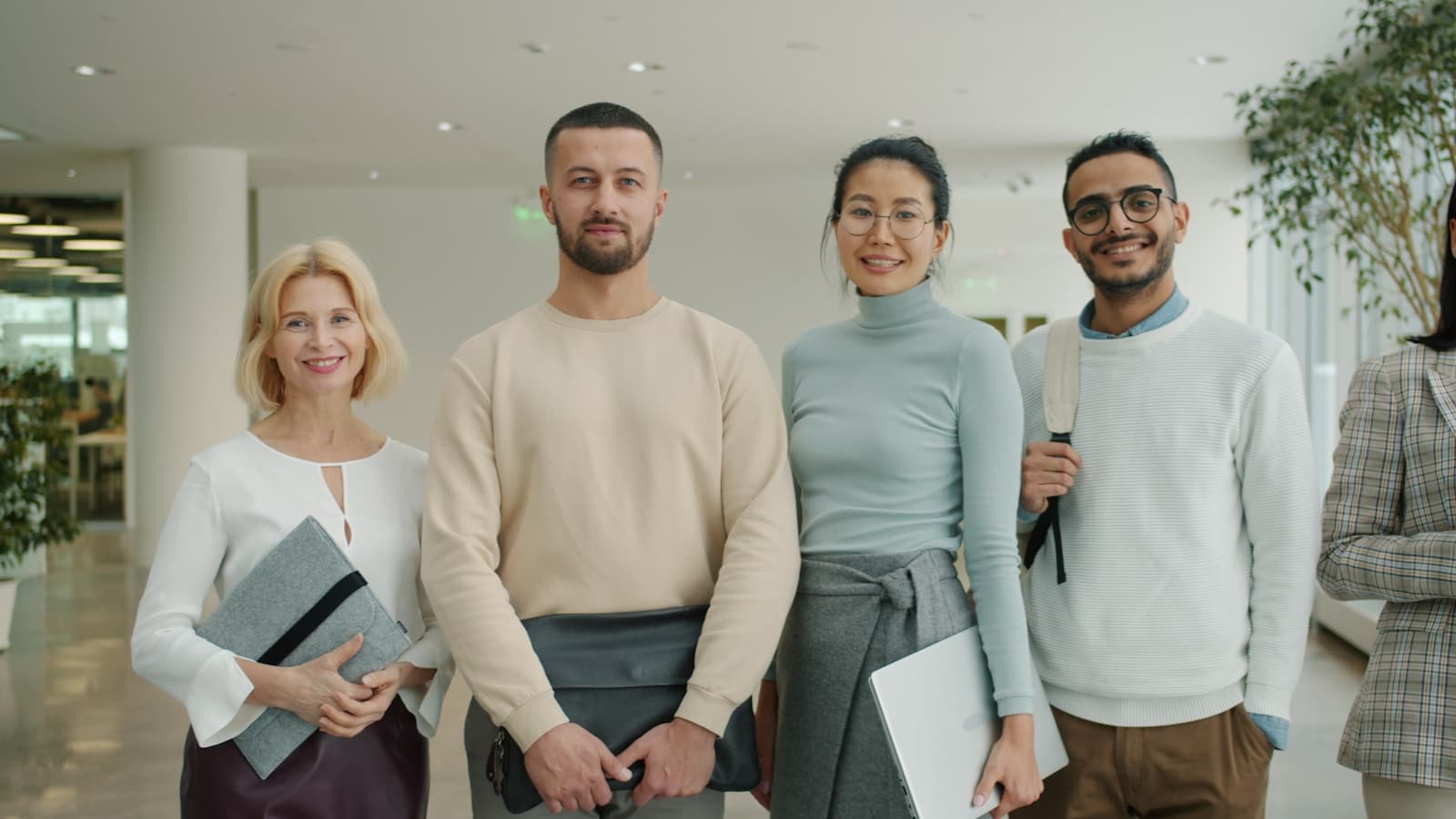 Consulting professionals standing together in a modern office lobby